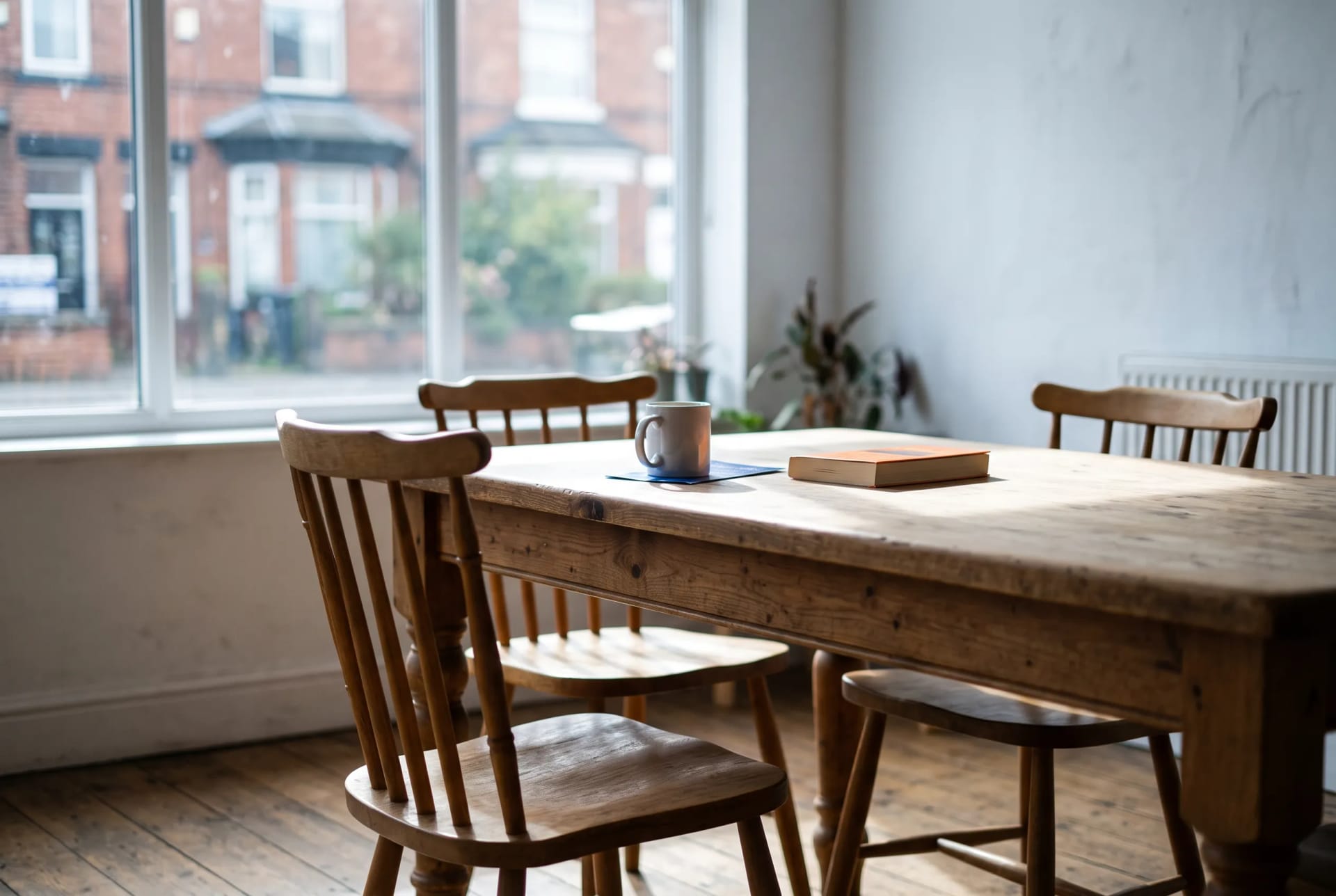 Two drinks and an open notebook on the mentoring table at the Beacon Community Rooms in Levenshulme, Manchester